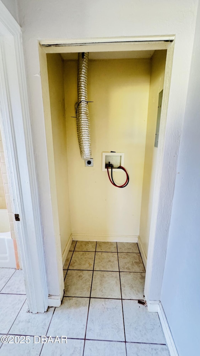 laundry area with electric dryer hookup, washer hookup, and light tile patterned floors