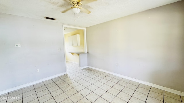 empty room featuring ceiling fan and a textured ceiling