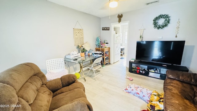 living room with light hardwood / wood-style flooring