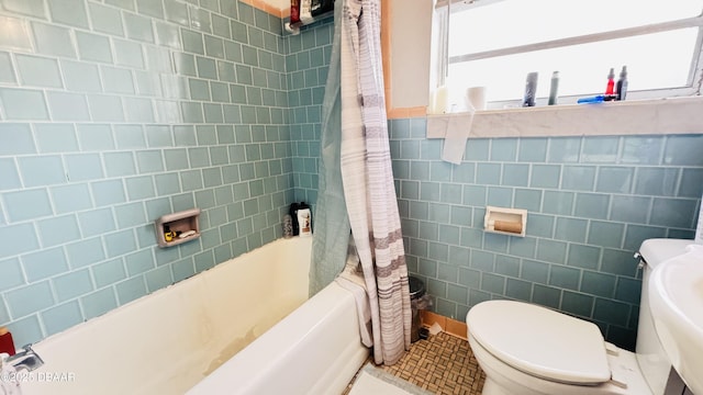 bathroom with tile walls, toilet, and shower / bathtub combination with curtain