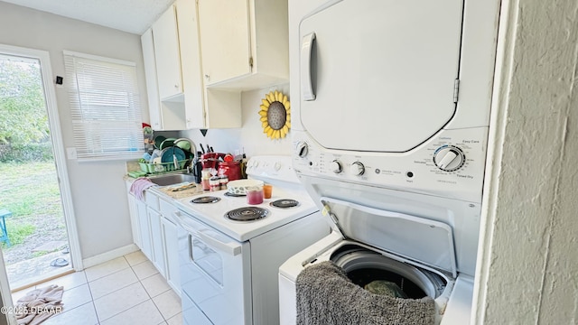 kitchen featuring sink, white cabinetry, light tile patterned floors, white electric stove, and stacked washing maching and dryer