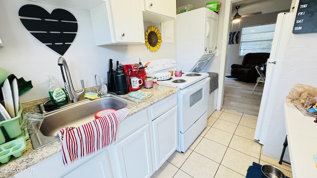 kitchen featuring sink, white appliances, ceiling fan, white cabinetry, and light tile patterned flooring