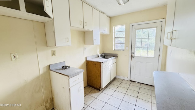 interior space featuring light tile patterned flooring and sink