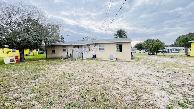 rear view of property featuring central AC