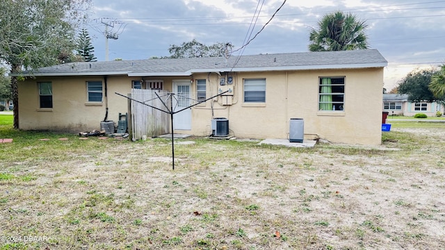 back of property featuring central AC