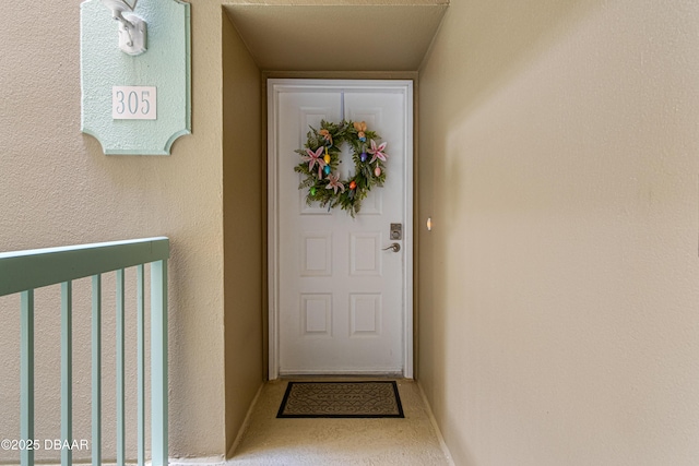 view of exterior entry with stucco siding