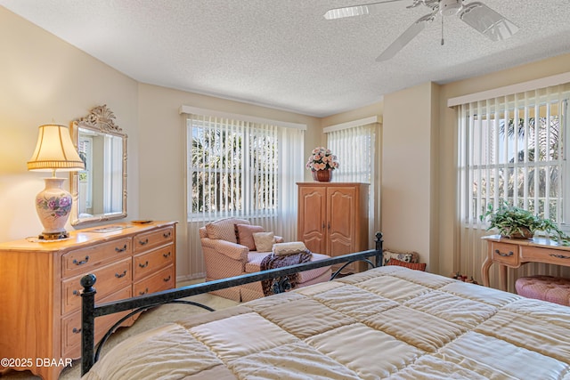 bedroom featuring a textured ceiling and multiple windows