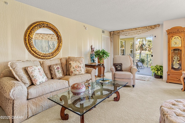 living area featuring carpet, a textured ceiling, and visible vents