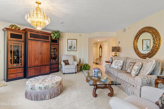 living room with a textured ceiling, visible vents, light carpet, and an inviting chandelier