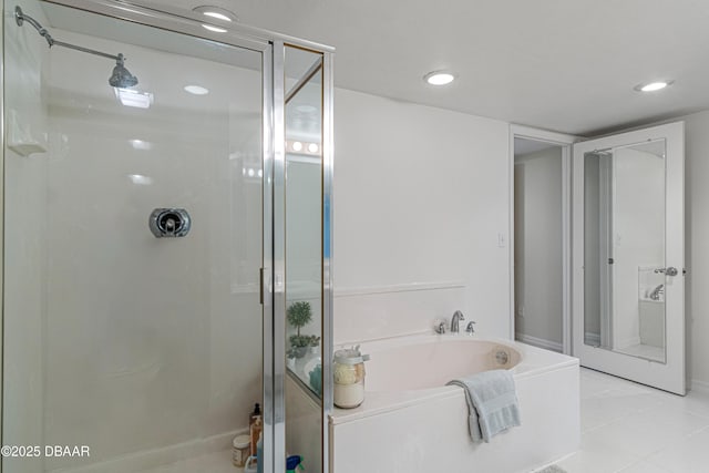bathroom with recessed lighting, tile patterned floors, a shower stall, and a bath