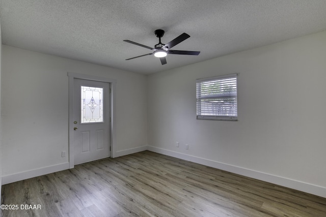 1704 Travelers Palm Dr, Edgewater, FL 32132 - spare room with wood finished floors, a textured ceiling, baseboards, and a ceiling fan