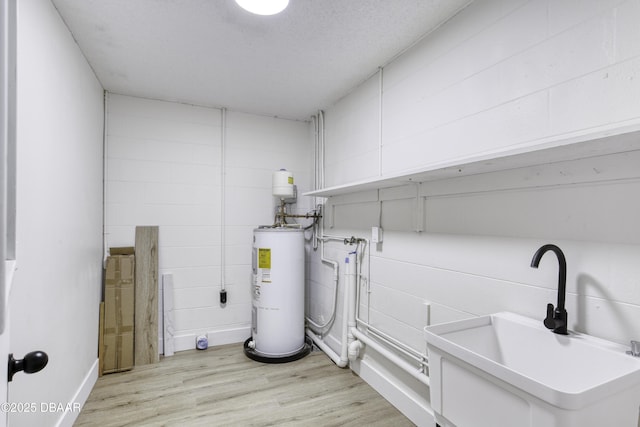 1704 Travelers Palm Dr, Edgewater, FL 32132 - clothes washing area with water heater, light wood-type flooring, and concrete block wall