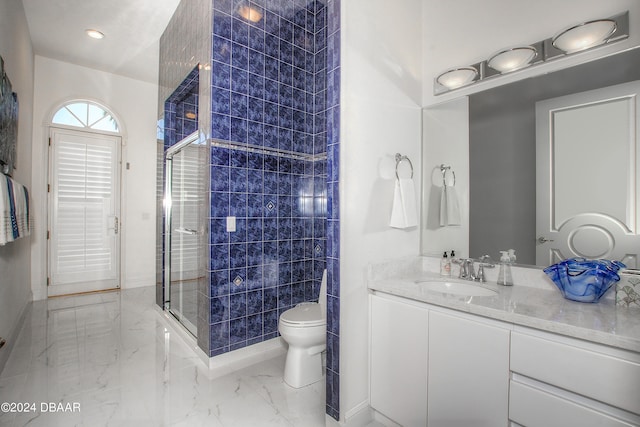 bathroom with walk in shower, vanity, and toilet