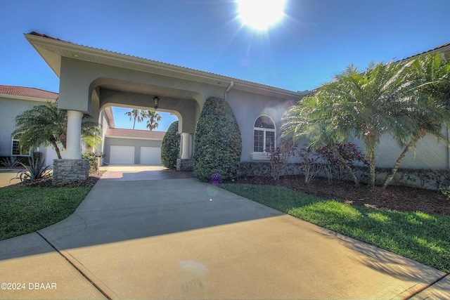 2540 Taxiway Echo, Port Orange, FL 32128 - view of front facade with driveway, a garage, stucco siding, and a tile roof