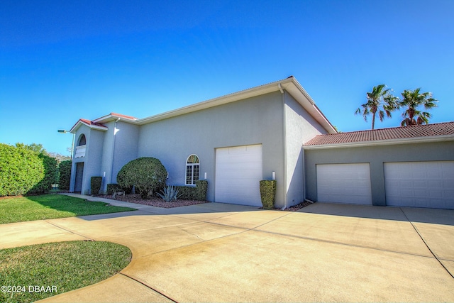 2540 Taxiway Echo, Port Orange, FL 32128 - view of side of home featuring an attached garage, driveway, and stucco siding