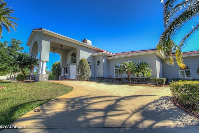 2540 Taxiway Echo, Port Orange, FL 32128 - mediterranean / spanish house featuring stucco siding, a front lawn, and driveway