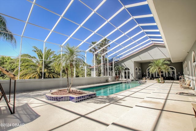 view of swimming pool with a patio area and a lanai