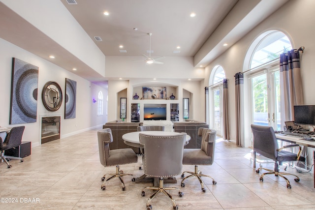 interior space featuring built in shelves, french doors, light tile patterned floors, and ceiling fan