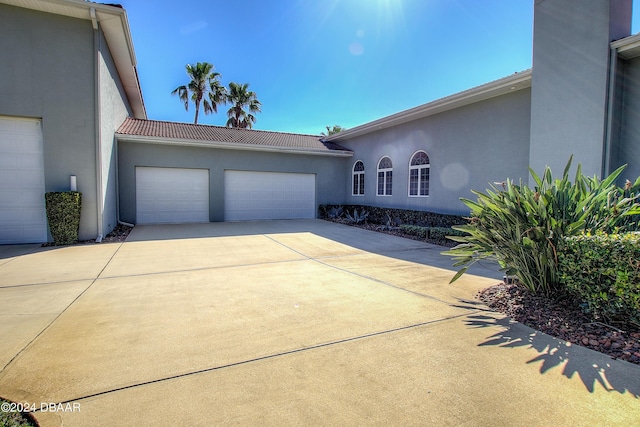 2540 Taxiway Echo, Port Orange, FL 32128 - view of front of home with an attached garage, driveway, stucco siding, and a tile roof