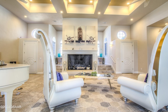 living room with ornamental molding and a towering ceiling