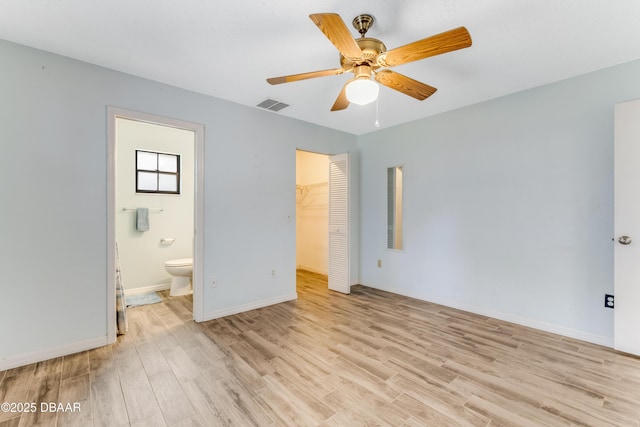 unfurnished bedroom with light wood-type flooring, baseboards, visible vents, and a closet