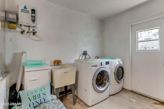 washroom with washing machine and dryer, a sink, and laundry area