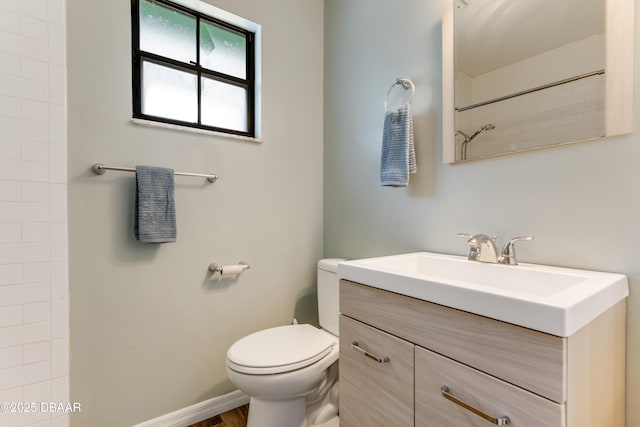 full bathroom with walk in shower, vanity, and toilet