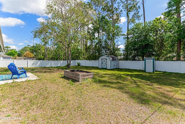 view of yard featuring a fenced backyard, an outbuilding, and a storage shed