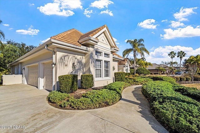 view of side of home featuring a garage