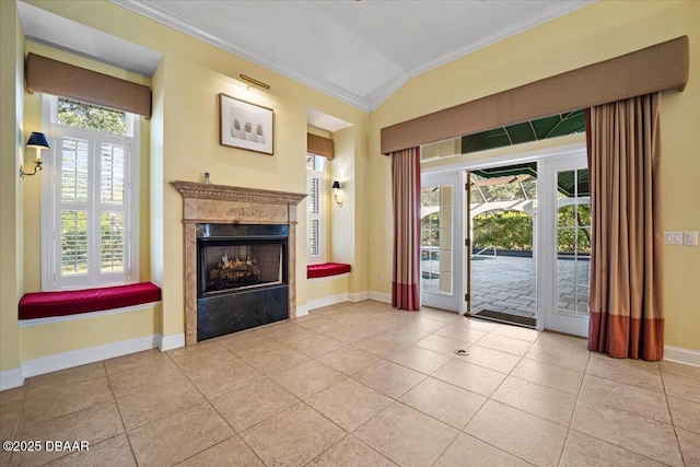 interior space featuring crown molding, lofted ceiling, a high end fireplace, and light tile patterned floors