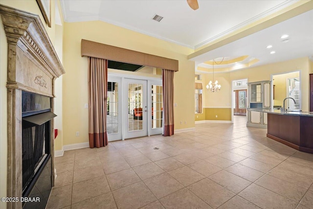 welcome area with french doors and ceiling fan with notable chandelier