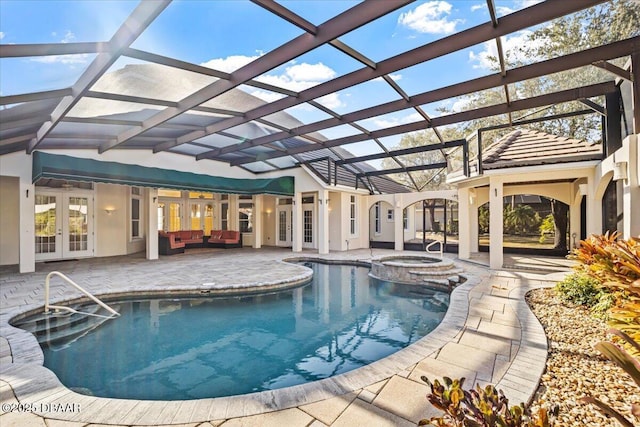 view of pool featuring a lanai, outdoor lounge area, a patio area, french doors, and an in ground hot tub