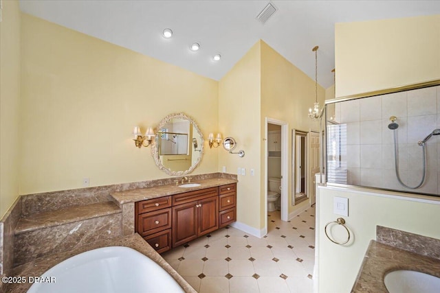 bathroom featuring toilet, a chandelier, high vaulted ceiling, a tile shower, and vanity