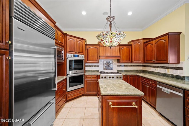 kitchen featuring light tile patterned floors, stainless steel appliances, ornamental molding, a kitchen island, and decorative light fixtures