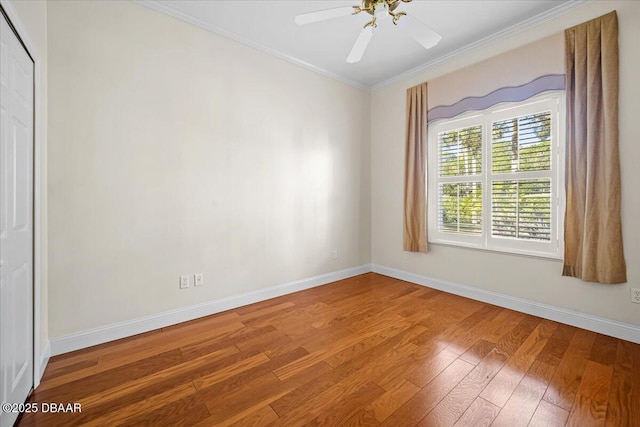 spare room featuring hardwood / wood-style flooring, ornamental molding, and ceiling fan