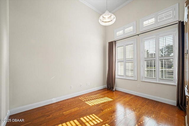 unfurnished room with crown molding and light hardwood / wood-style floors