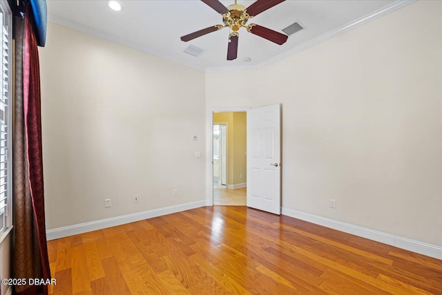 spare room with ornamental molding, ceiling fan, and light hardwood / wood-style floors