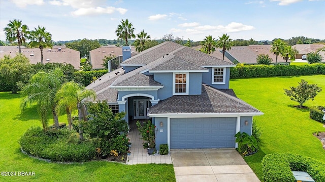 view of front of house with a garage and a front yard