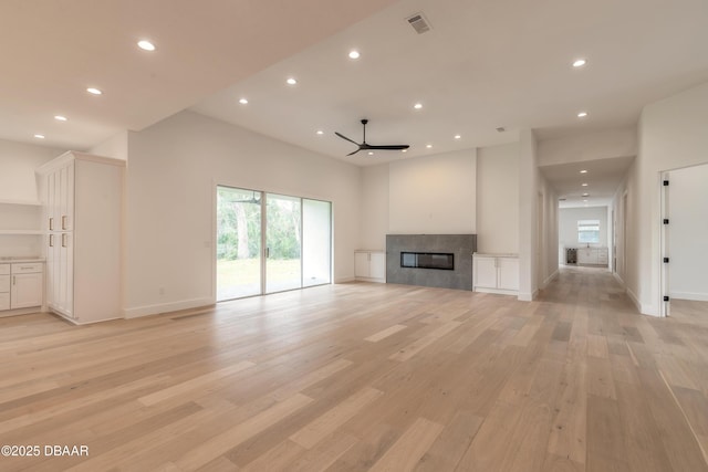 unfurnished living room with light hardwood / wood-style floors and ceiling fan