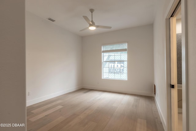 empty room featuring ceiling fan and light wood-type flooring