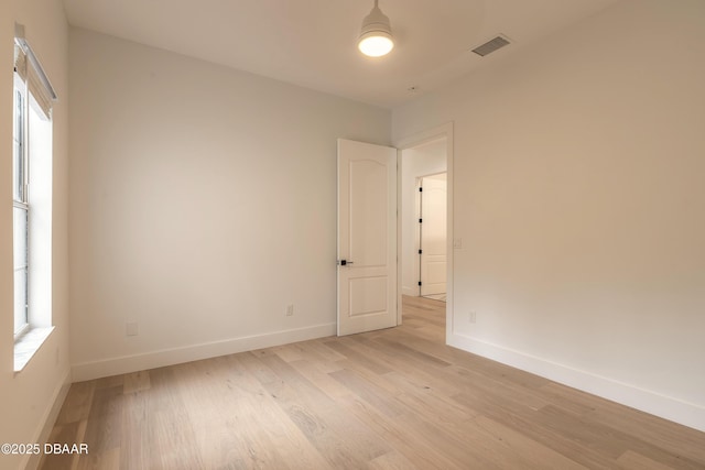 unfurnished room with light wood-type flooring