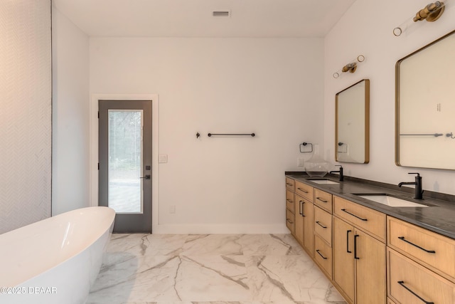 bathroom featuring vanity and a bath