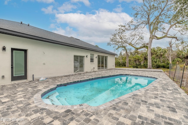 view of swimming pool with a patio area