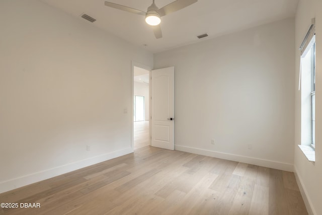 spare room with ceiling fan and light wood-type flooring