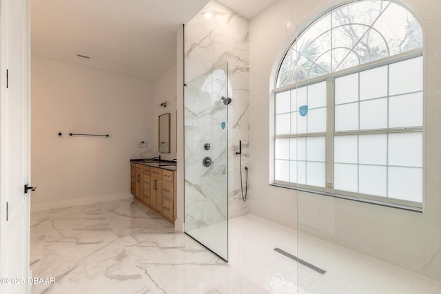 bathroom featuring vanity, a wealth of natural light, and a tile shower