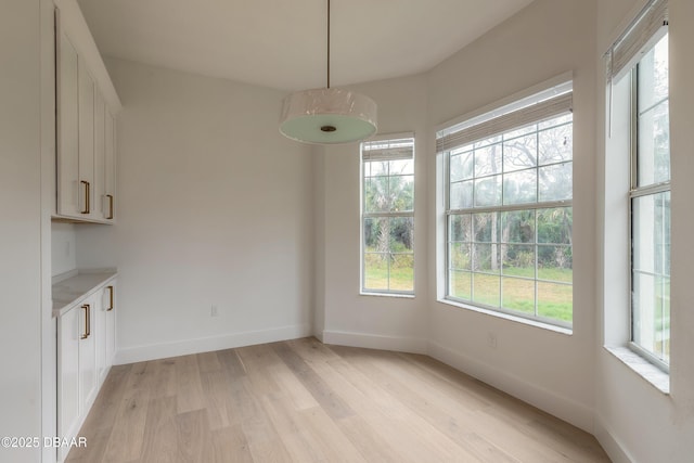 unfurnished dining area with light wood-type flooring