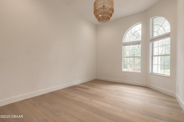 empty room with light hardwood / wood-style flooring