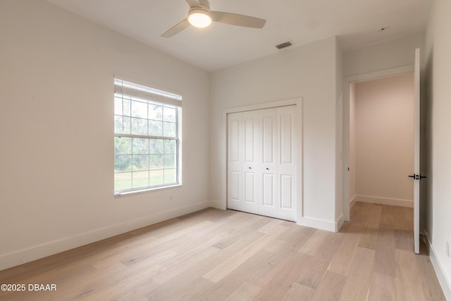 unfurnished bedroom with a closet, ceiling fan, and light hardwood / wood-style flooring