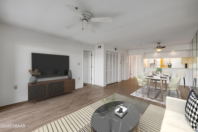 464 Bouchelle Dr Unit 104, New Smyrna Beach, FL 32169 - living area with visible vents, ceiling fan, wood finished floors, and baseboards