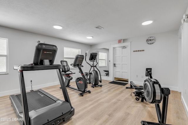 464 Bouchelle Dr Unit 104, New Smyrna Beach, FL 32169 - exercise room with wood finished floors, visible vents, and baseboards
